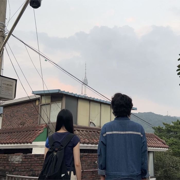 Audience member and performer looking toward Namsan Tower during The Touch of the Untouched