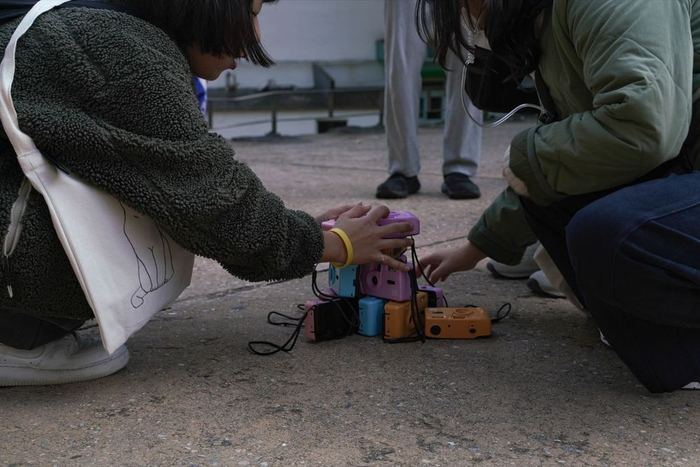 Participants holding disposable film cameras